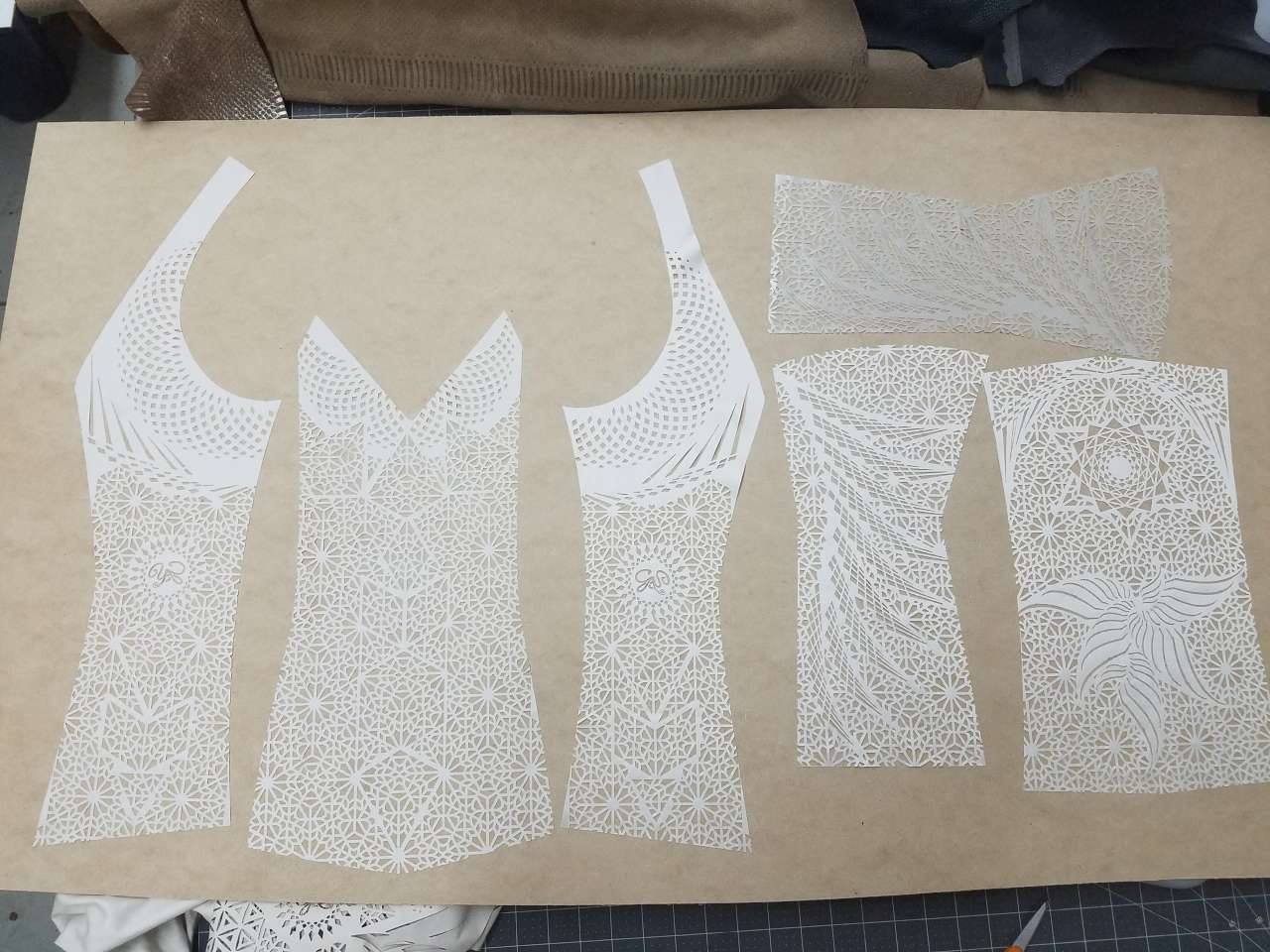 Laser cut fabric pieces laid out for the wedding outfits